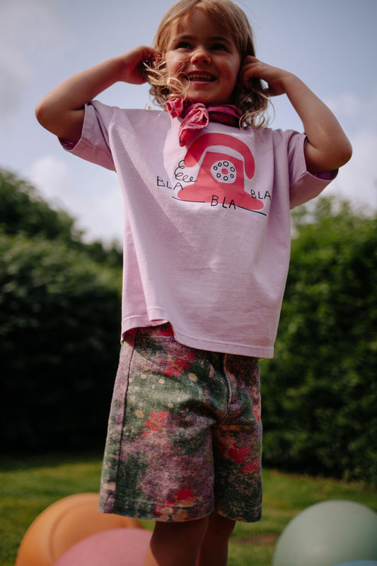 Meisje draagt lichtroze t-shirt met telefoonprint