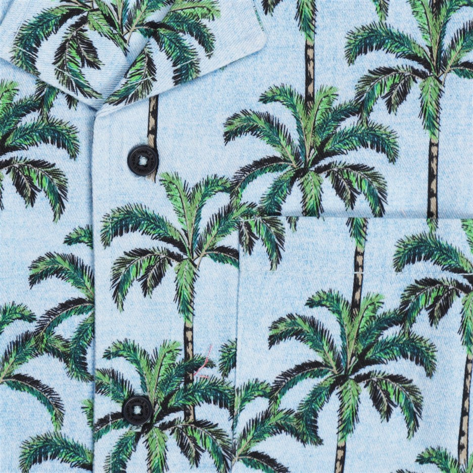 Detail palmbomen print op blauw hemd
