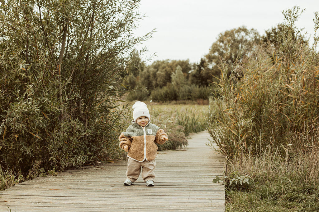 Zachtgroene teddy jas met zon.