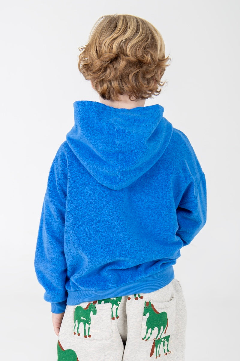 Blauwe hoodie van teddystof met Good Monster opdruk.