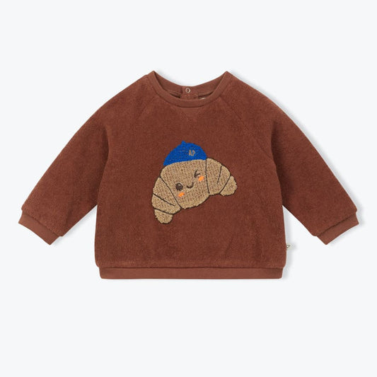 Bruine badstof baby sweater met croissant patch op de voorkant