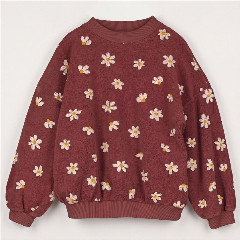 Bruine teddy sweater voor meisjes met all-over madeliefjesprint.