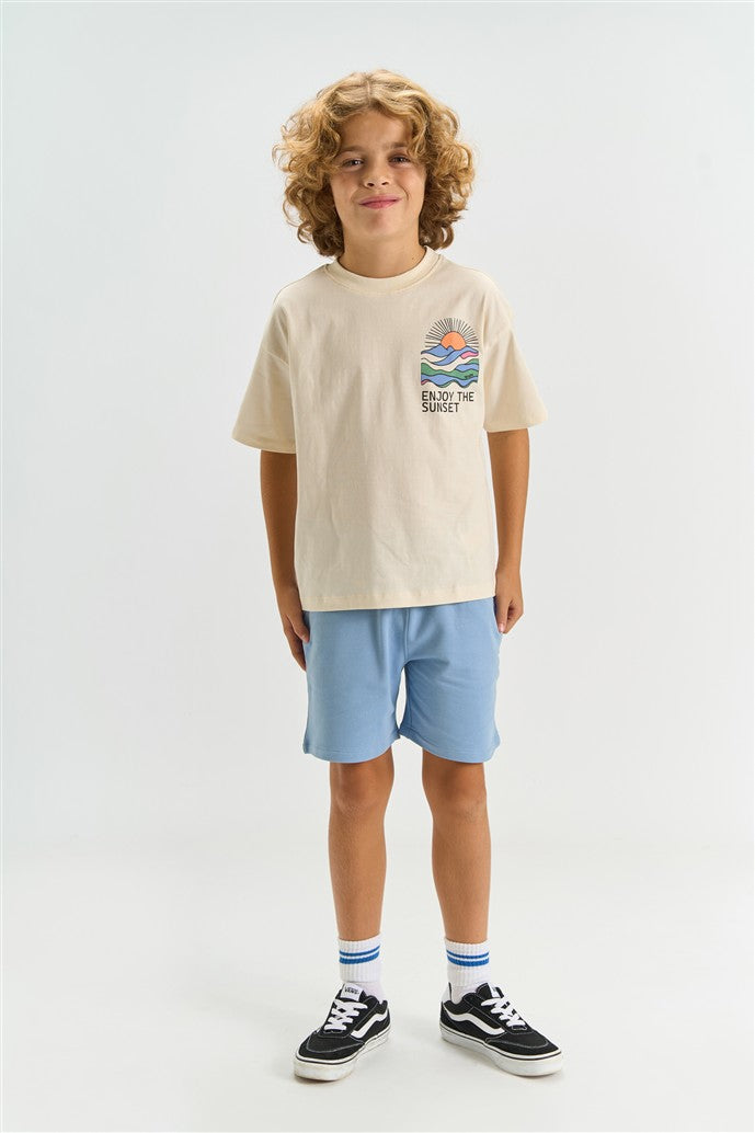 jongen draagt tshirt tuck gardenia van the new voorzijde